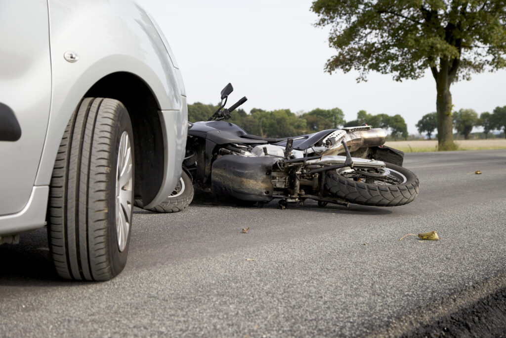 Image of a motorcycle accident with the motorycycle laying in the street